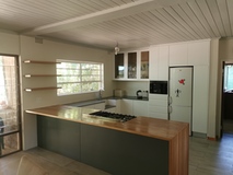Modern style kitchen, with white satin finishes and solid Oak tops